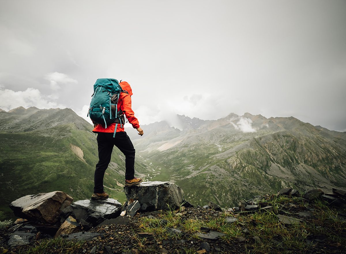 Hiker looking out over a misty mountain valley